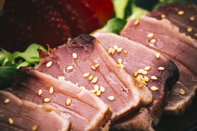 Close-up of tuna tataki garnished with sesame seeds