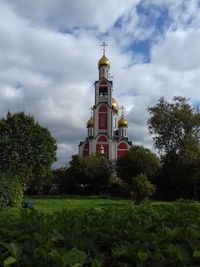 Low angle view of church against cloudy sky