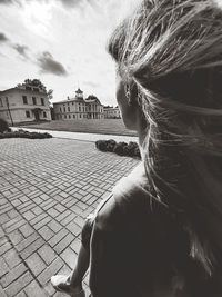 Rear view of woman looking at buildings in city