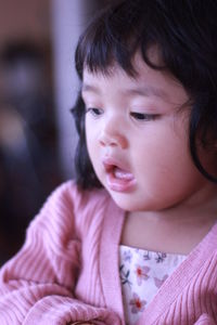 Close-up portrait of cute girl looking away