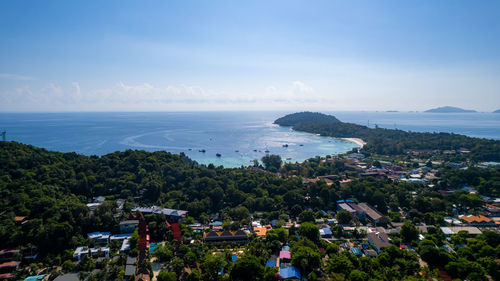 High angle view of townscape by sea against sky