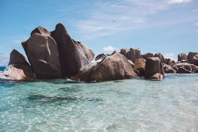 Rocks by sea against sky