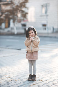 Cute girl standing on street