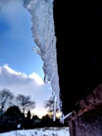 Close-up of frozen water against sky