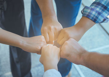 Midsection of couple holding hands