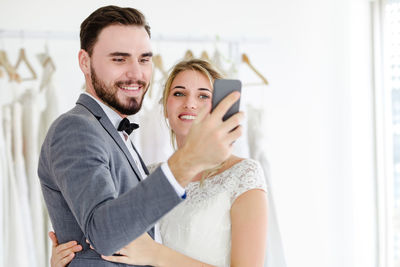 Portrait of a smiling young man using smart phone