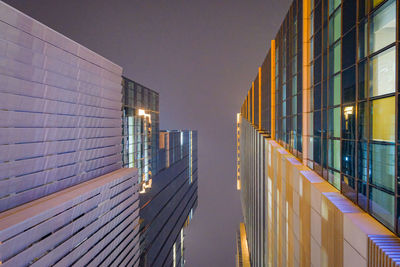 Illuminated building against sky at dusk