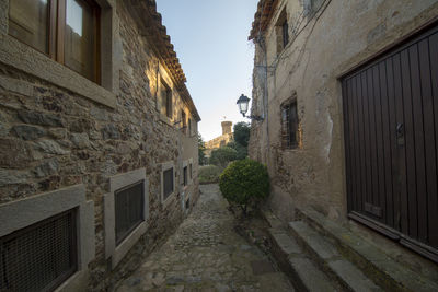 Narrow alley amidst old buildings against sky