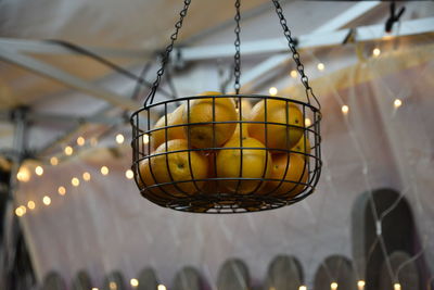 Low angle view of illuminated lighting equipment hanging from ceiling