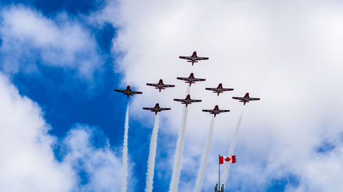 Low angle view of airshow against sky