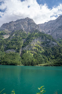 Scenic view of lake and mountains against sky