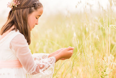 Girl with eyes closed in field