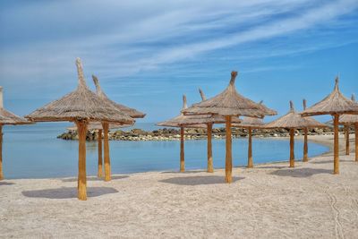 Gazebo on beach against sky