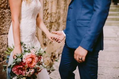 Midsection of couple during wedding ceremony