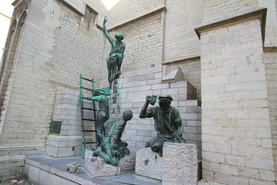 Low angle view of statues on wall