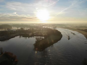 Scenic view of river against sky during sunset