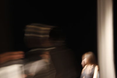 Blurred motion of people in darkroom