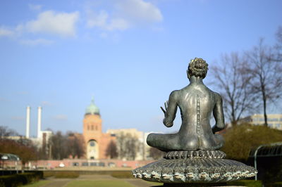 Statue in temple against sky