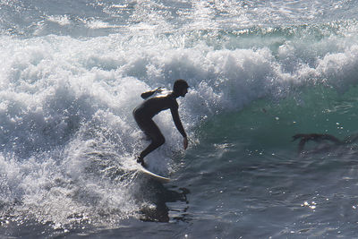 Full length of man surfing in sea