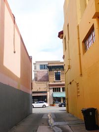 Street amidst buildings in city against sky