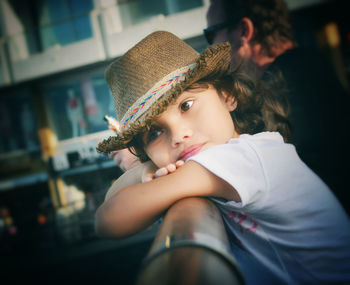 Side view of girl leaning on railing