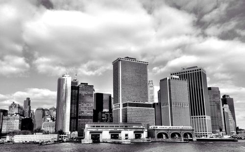 Modern buildings against cloudy sky