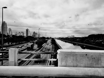 Railroad tracks in city against sky