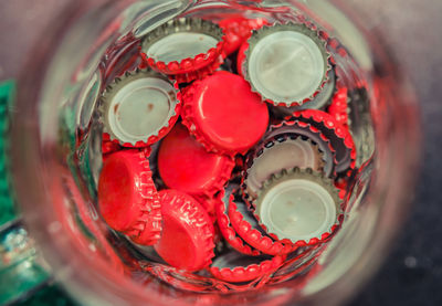 High angle view of red caps in jar