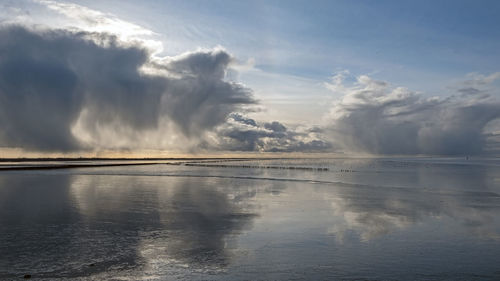 Incredible cloudscape at the wadden sea near holwerd in the netherlands at sunset