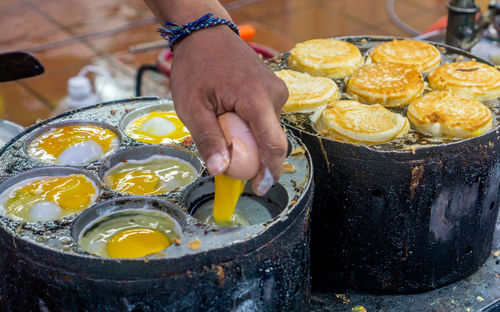 Midsection of man preparing food at market stall