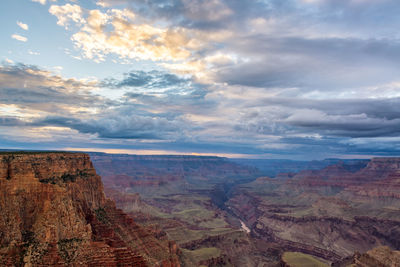 Scenic view of eroded landscape at grand canyon national park against cloudy sky