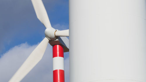 Low angle view of cropped hand holding equipment