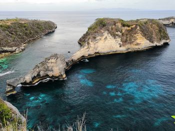 High angle view of rocks on sea shore