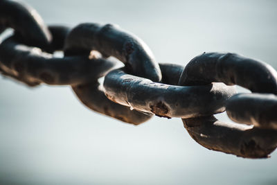 Close-up of chain against sky