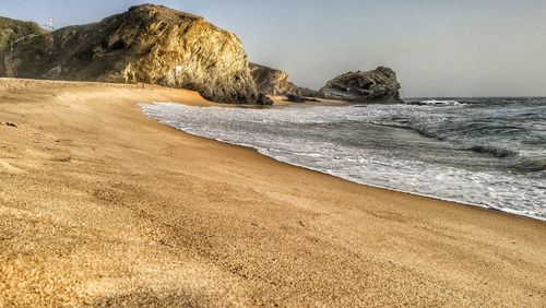 Scenic view of beach against clear sky