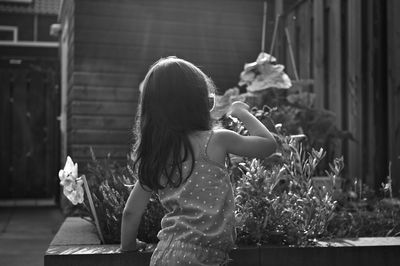 Rear view of girl in yard