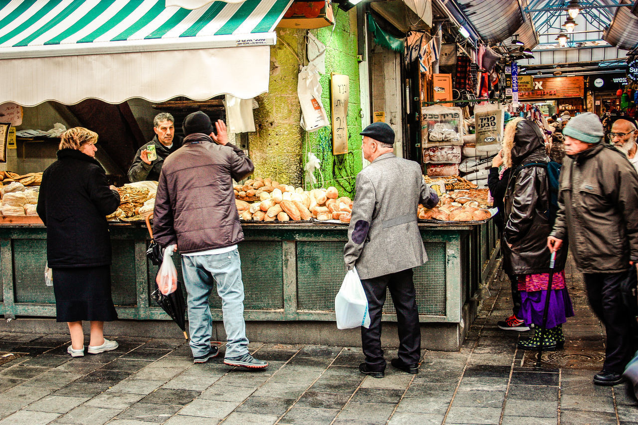 FULL LENGTH REAR VIEW OF PEOPLE AT MARKET