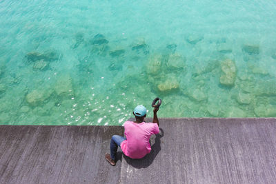 High angle view of man sitting in swimming pool