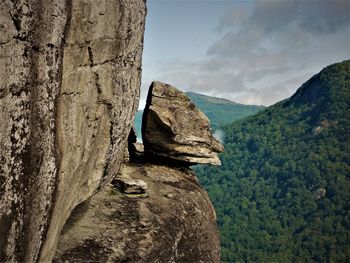 Close-up of rock on mountain against sky