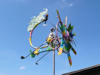 Low angle view of flowering plant against blue sky