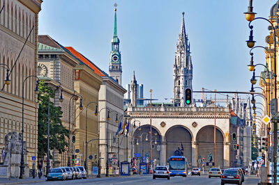 Road leading towards historic church against sky in city