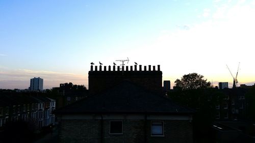 Buildings against sky at sunset