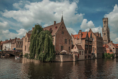 Boats and old buildings on canal at bruges. a town full of canals and old buildings in belgium.