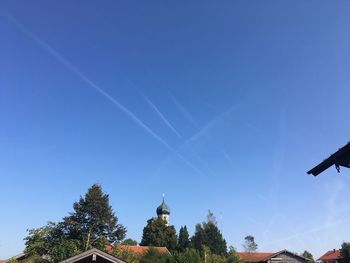 Low angle view of vapor trail against clear blue sky