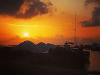 Scenic view of silhouette mountains against orange sky