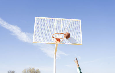 Young man playing basketball on court