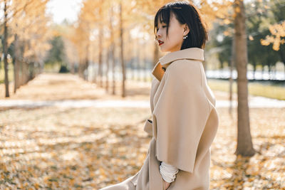 Side view of woman standing at park
