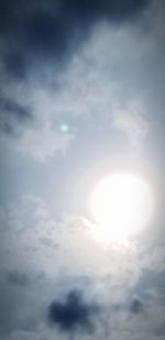 Low angle view of bright sun in sky