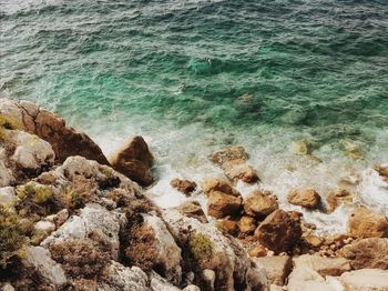 High angle view of rocks at sea shore