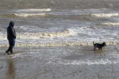 Full length of man walking on shore at beach